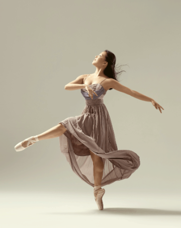 Female dancer in left - brown long floaty dress and pointe shoes, credit Rachel Neville