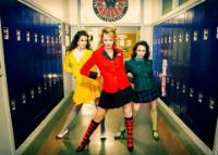 3 students in a hallway with lockers either side in a scene from The Heathers musical