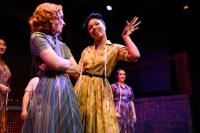 2 women in 1950s dress in a scene from The Pajama Game