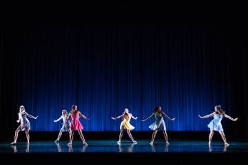 4 female dancers twirling in pastel color costumes 