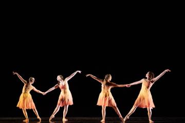 2 pairs of female dancers in ombre yellow to red skirted costumes