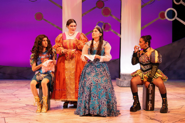 2 women standing, a man dressed as a woman sitting, and a woman dressed as a man kneeling, all in Elizabethan clothing