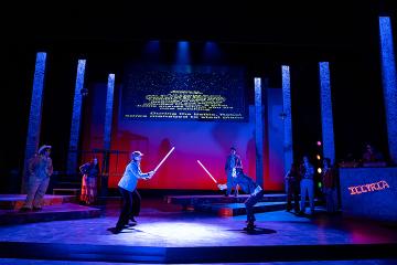 2 characters in a lightsaber duel with text scrolling behind them like Star Wars