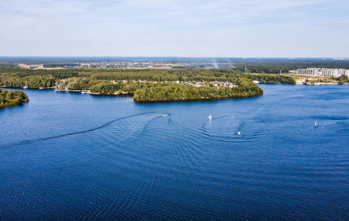 A large blue lake surrounded by a town. 