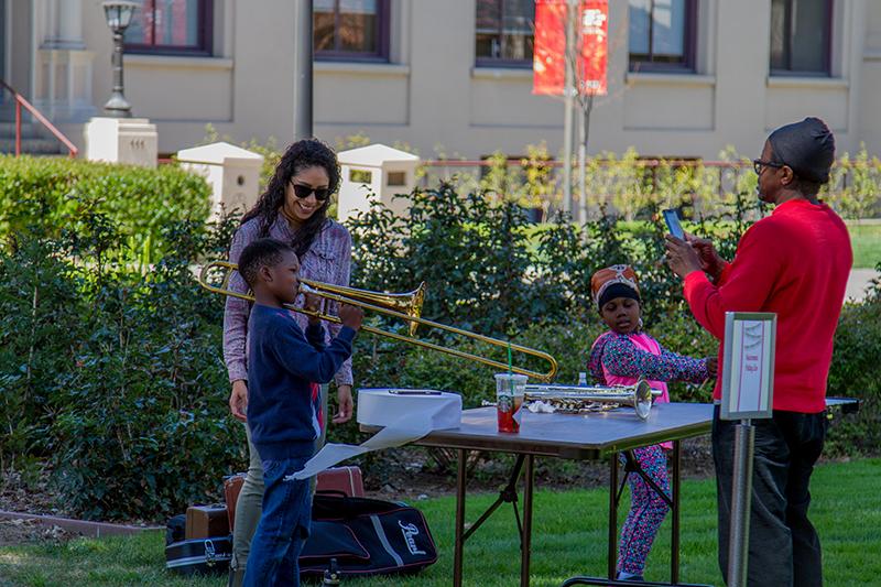 Guests playing with instruments at Jazz Appreciation Family Day image link to story