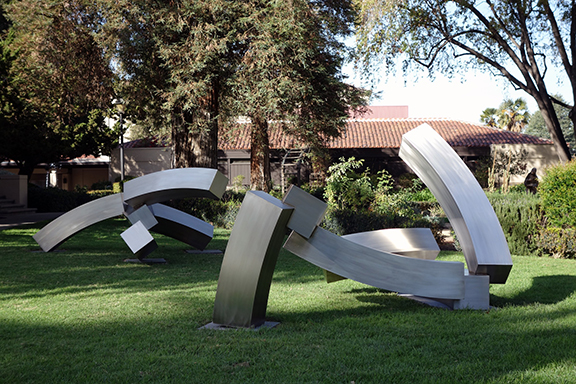 Two monumental geometric stainless steel sculptures by Brian Wall.
