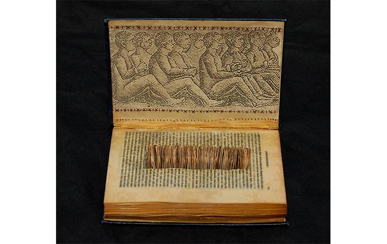 Book converted into sculpture with rectangular area removed from text block and filled with receipt tags