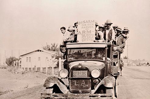 New Deal era image of protesters crowded on the back of a pick-up.