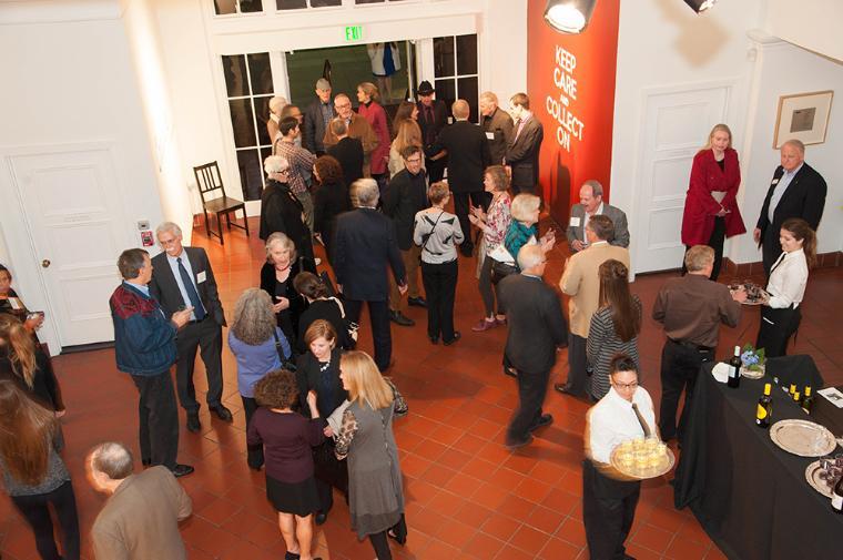 Crowd of people enjoying a museum reception.