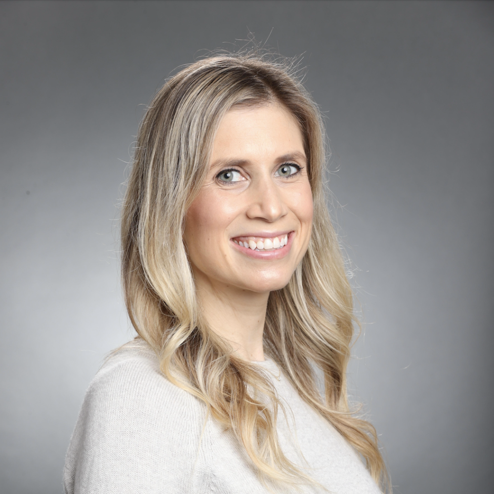 Smiling person with grey background. Image labeled Kelli McCormick Thumbnail.