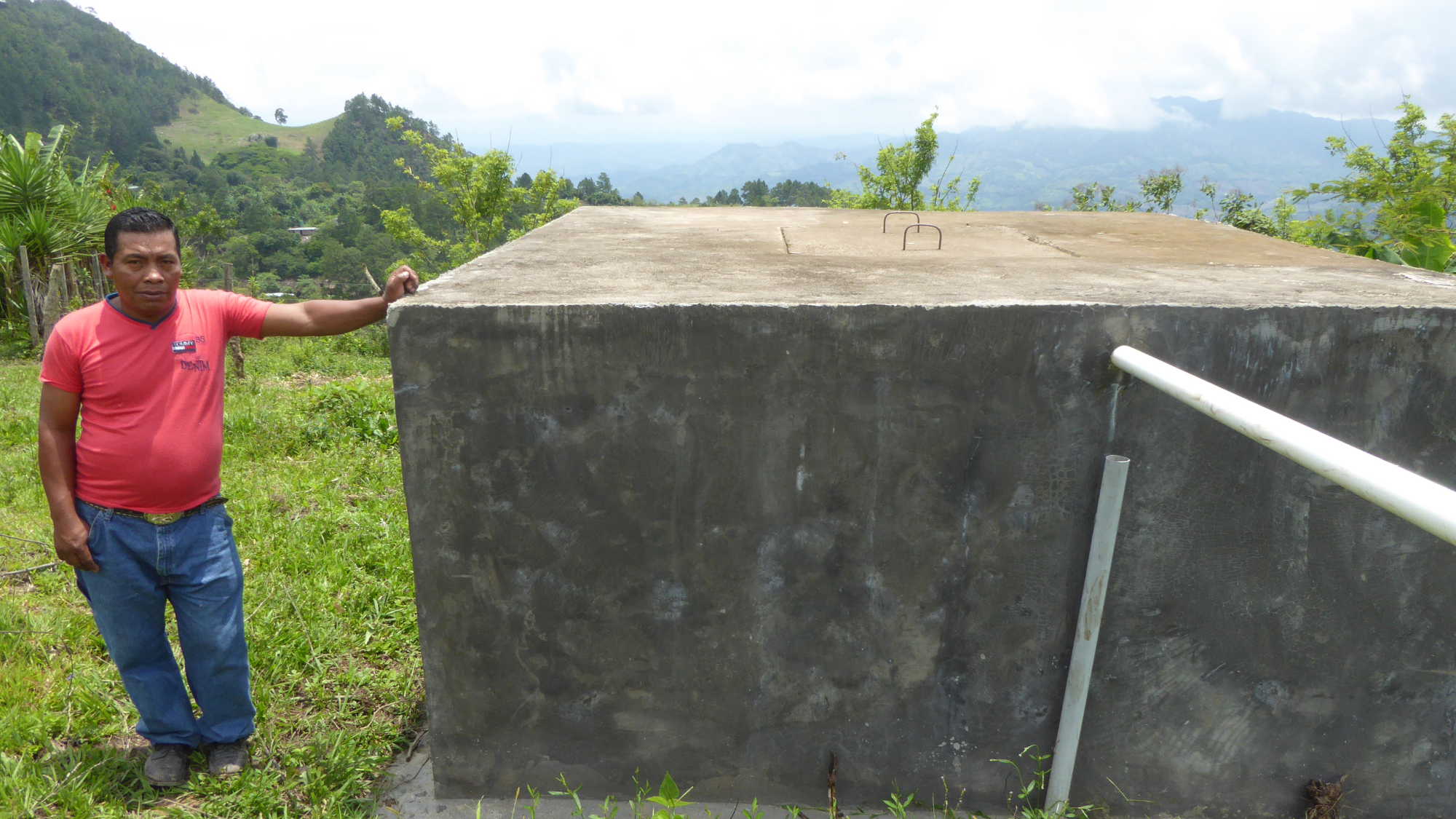 Person standing next to water tank