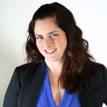 A woman smiling in business attire.