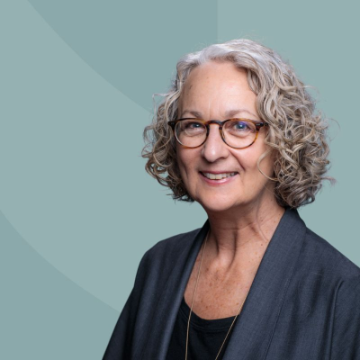 A woman smiling. Georganne is a member of the Investment Committees for Santa Clara University.