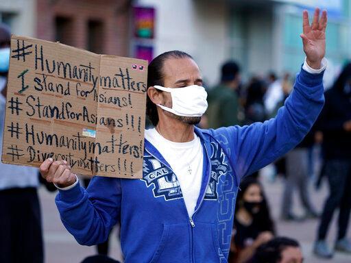 An Asian man demonstrates at a anti-Asian violence protest