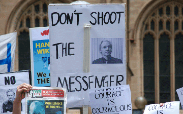 Protesters express their opinions about Julian Assange.