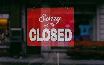a closed for business sign in window