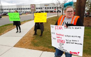 workers protest outside company building for better protection against coronavirus
