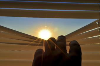 Sun revealed through window blinds