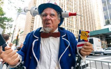 A protester wears an Uncle Sam outfit at a demonstration against COVID-19 vaccination mandates, Wednesday, Aug. 25, 2021, in New York. (AP Photo/Mary Altaffer)