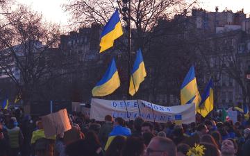 People with Ukrainian flags protesting for the war in Ukraine