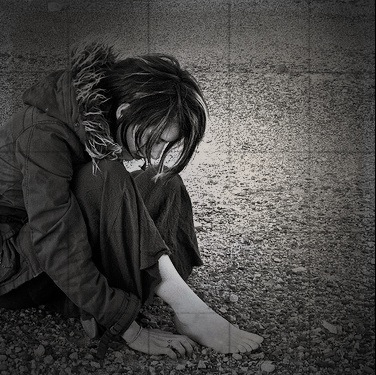 Person sitting on the ground image link to story