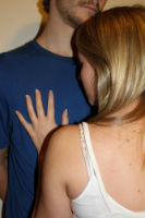 Young woman with her hand on a man's chest