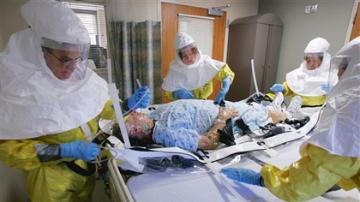 In this file photo from Oct. 28, 2006, a mock patient is cared for during a drill at the Nebraska biocontainment unit in the Nebraska Medical Center in Omaha, Neb. (AP Photo/Nati Harnik)