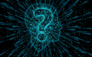 A silhouette of human head with a question mark.