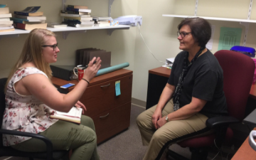 Two women sitting in an office having an interview.