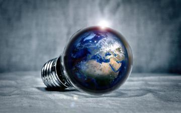 A light shines to reveal the earth inside a lightbulb.