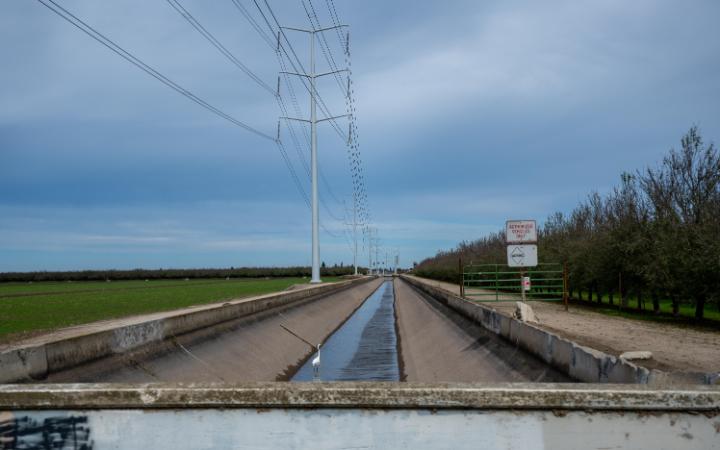Power lines and water canal at Concentrated Animal Feeding Operation. Photograph by Andrew Schatz. 