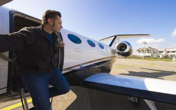 man deplaning from a private jet