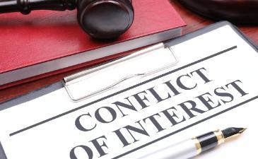 A desktop with book, gavel, clipboard, and pen, and document that has the words, 