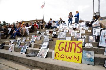 People holding signs and gathering at a gun violence rally. image link to story