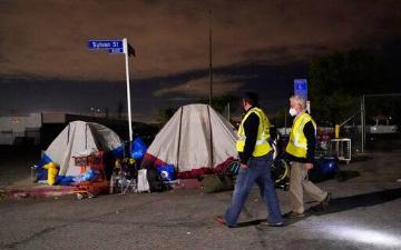 Los Angeles city councilmember Paul Krekorian, right, walks past tents where people are living as he walks with staff member Karo Torossian during an official homeless count Tuesday, Feb. 22, 2022, in the North Hollywood section of Los Angeles. AP Photo/Marcio Jose Sanchez