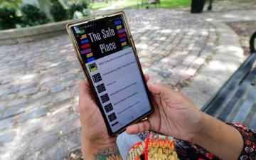 Jasmin Pierre poses for a photo with her smartphone app in New Orleans Thursday July 2 2020 She created The Safe Place a free Blackoriented mental health app thats seen more signups during the pandemic AP PhotoGerald Herbert