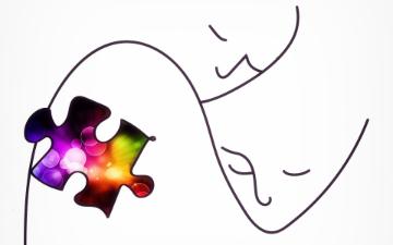 A drawing of two figures embracing and a puzzle piece representing autism disorder is moving along on a spectrum