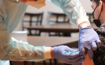 medical professional giving a vaccine to a patient