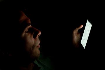 man looking at phone screen