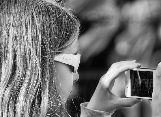 kid looking at smartphone screen