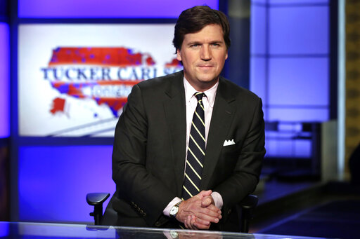 Tucker Carlson, host of Tucker Carlson Tonight, poses for photos in a Fox News Channel studio, in New York, 2017. image link to story