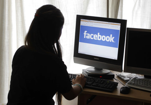 Girl at computer looking at Facebook (AP Photo/Paul Sakuma, File)