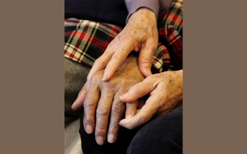 Shou-Mei Li holds the hand of her husband Hsien-Wen Li, who is an Alzheimer's patient, at their home in San Francisco, in this photo taken, Thursday, Sept. 1, 2011.  (AP Photo/Ben Margot)