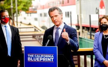 California Governor Gavin Newsom discusses his budget proposal, dubbed the California Blueprint, on Thursday, Jan. 13, 2022, in Santa Clara, Calif. Santa Clara Mayor, Lisa Gilmor, on far right. AP Photo-Noah Berger