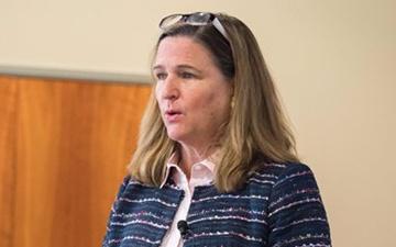 A person in a striped blazer speaking. image link to story