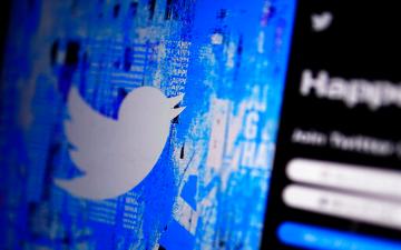 Twitter Logo displayed on a digital screen with login interface. image link to story