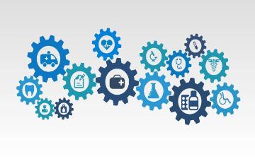 Gears with various healthcare symbols, including a heart, stethoscope, and ambulance. image link to story