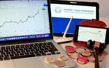 Laptop, tablet, and smartphone displaying charts and Bitcoin logos on a desk. image link to story