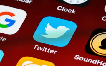 Twitter app icon on a smartphone screen. image link to story
