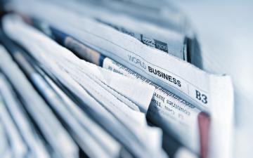 A stack of folded newspapers close-up. image link to story